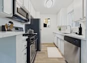 Thumbnail 1 of 108 - A modern kitchen with black appliances and white cabinets.