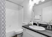 Thumbnail 71 of 95 - a bathroom with a sink and a toilet and a shower