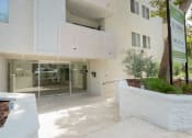 Thumbnail 26 of 28 - the entrance to a white building with a glass door