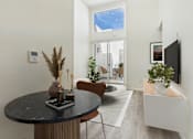 Thumbnail 6 of 61 - A modern dining room with a round table and chairs.