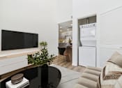 Thumbnail 4 of 61 - A black table with a plant on it and a white fridge in the background.