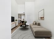 Thumbnail 2 of 61 - A living room with a grey rug, a brown sofa, and a coffee table.