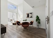 Thumbnail 13 of 61 - A modern dining room with a wooden table and chairs.