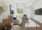 Thumbnail 3 of 45 - A modern living room with a wooden table and a large painting on the wall.