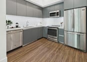 Thumbnail 2 of 45 - A modern kitchen with stainless steel appliances and wooden flooring.