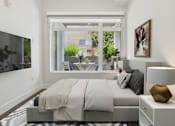 Thumbnail 7 of 45 - A modern bedroom with a large bed and a view of the outdoors.