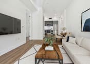 Thumbnail 5 of 45 - A modern living room with a white couch and a wooden coffee table.