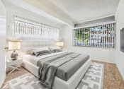 Thumbnail 8 of 36 - A bedroom with a large bed and a window with blinds.