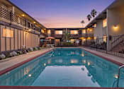 Thumbnail 36 of 36 - A swimming pool in a residential area with a sunset in the background.