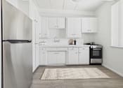 Thumbnail 1 of 16 - A modern kitchen with white cabinets and a stainless steel refrigerator.