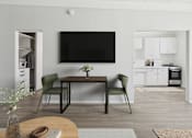 Thumbnail 3 of 16 - A modern living room with a flat screen TV mounted on the wall.