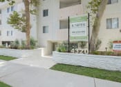 Thumbnail 27 of 28 - the entrance to a apartment building with a sign for the junior apartments