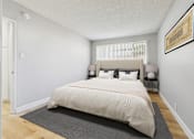 Thumbnail 16 of 37 - A bedroom with a large bed and a framed picture on the wall.
