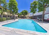 Thumbnail 55 of 55 - A swimming pool surrounded by a fence and trees.