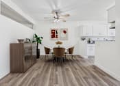 Thumbnail 3 of 55 - A dining room with a wooden floor and a white ceiling fan.