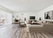 Thumbnail 6 of 55 - A living room with a couch, chair, and television.