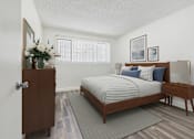 Thumbnail 8 of 55 - A bedroom with a bed, nightstand, and a wooden door.