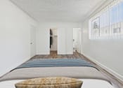 Thumbnail 10 of 55 - A bedroom with a bed and a window with blinds.