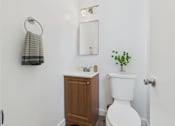 Thumbnail 12 of 55 - A white toilet with a plant on top of it.