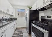 Thumbnail 1 of 55 - A kitchen with a black refrigerator and stove.