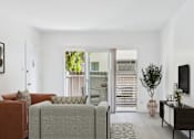 Thumbnail 5 of 37 - A living room with a grey couch and a brown armchair.
