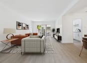 Thumbnail 4 of 37 - A living room with a grey sofa and a brown armchair.