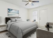 Thumbnail 2 of 12 - A bedroom with a bed, chair, and a ceiling fan.