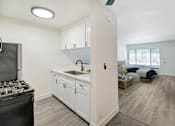 Thumbnail 8 of 83 - an open kitchen and living room with a stove and a window