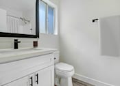 Thumbnail 16 of 83 - an empty bathroom with a toilet and a sink
