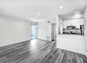 Thumbnail 83 of 102 - the living room and kitchen of a new home with white walls and wood floors
