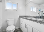 Thumbnail 90 of 102 - a white bathroom with a toilet and a sink