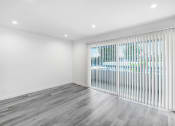 Thumbnail 78 of 102 - an empty living room with a large window with blinds