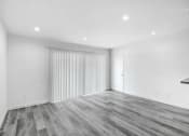 Thumbnail 84 of 102 - a living room with white walls and wood flooring and a sliding closet