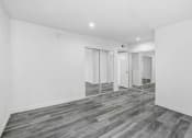 Thumbnail 82 of 102 - a renovated living room with white walls and a mirrored closet