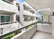 Thumbnail 21 of 102 - a view of a building with white concrete walls and balconies