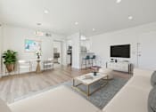 Thumbnail 14 of 118 - A modern living room with a grey sofa and a coffee table.