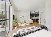Thumbnail 29 of 157 - A modern living room with a large window and a white couch.