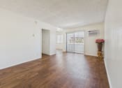 Thumbnail 5 of 61 - A room with wooden floors and white walls.