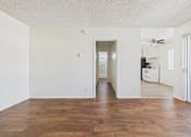 Thumbnail 3 of 61 - A room with wooden floors and white walls.