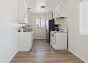 Thumbnail 2 of 61 - A kitchen with white cabinets and appliances.