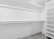 Thumbnail 11 of 24 - Empty white shelves in a room.