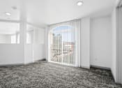Thumbnail 19 of 24 - A room with a carpeted floor and a sliding glass door.