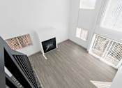 Thumbnail 20 of 24 - A modern living room with a fireplace and a staircase.