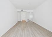 Thumbnail 10 of 15 - A room with a white wall and a wooden floor.