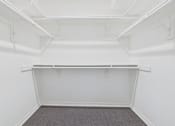 Thumbnail 28 of 30 - A white room with a grey carpet and a white shelf.