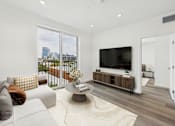 Thumbnail 5 of 13 - A modern living room with a large window overlooking the city.