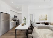 Thumbnail 2 of 13 - A modern kitchen with a dining table and chairs.