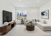 Thumbnail 11 of 13 - A modern living room with a large window overlooking the city.