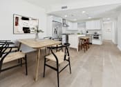 Thumbnail 2 of 44 - A kitchen with a table and chairs in front of it.