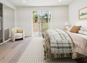 Thumbnail 5 of 44 - A bedroom with a large bed and a chair.